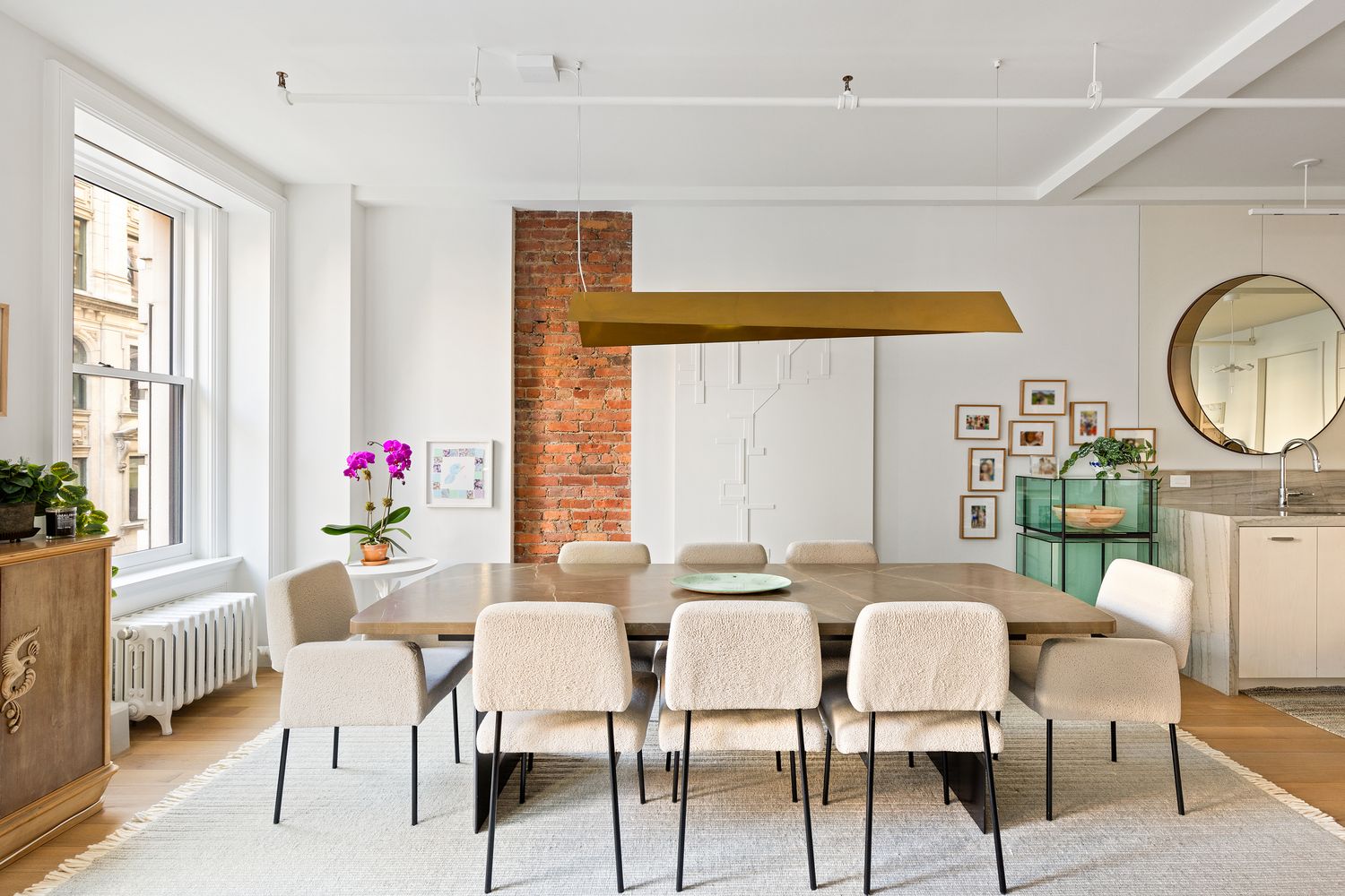 a dining room with furniture and a large window