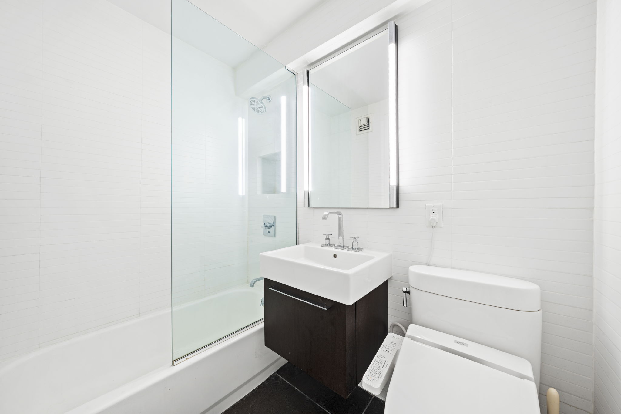 330 3rd Avenue, Unit 8D Manhattan, NY 10010 - Photo 8 of 11 a bathroom with a sink a toilet and a mirror
