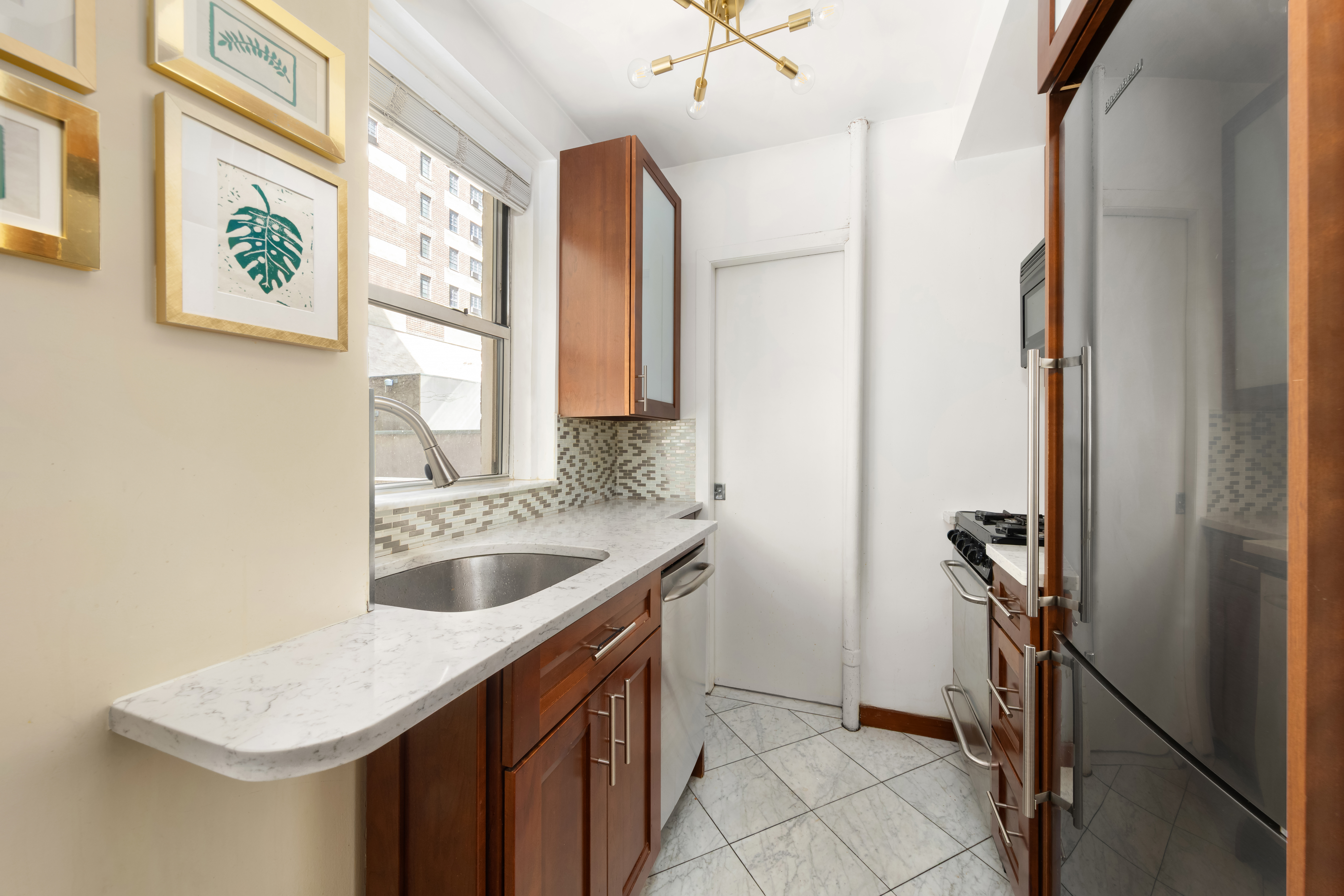 333 East 43rd Street, Unit 110/111 Manhattan, NY 10017 - Photo 2 of 16 a bathroom with a sink vanity granite and a mirror
