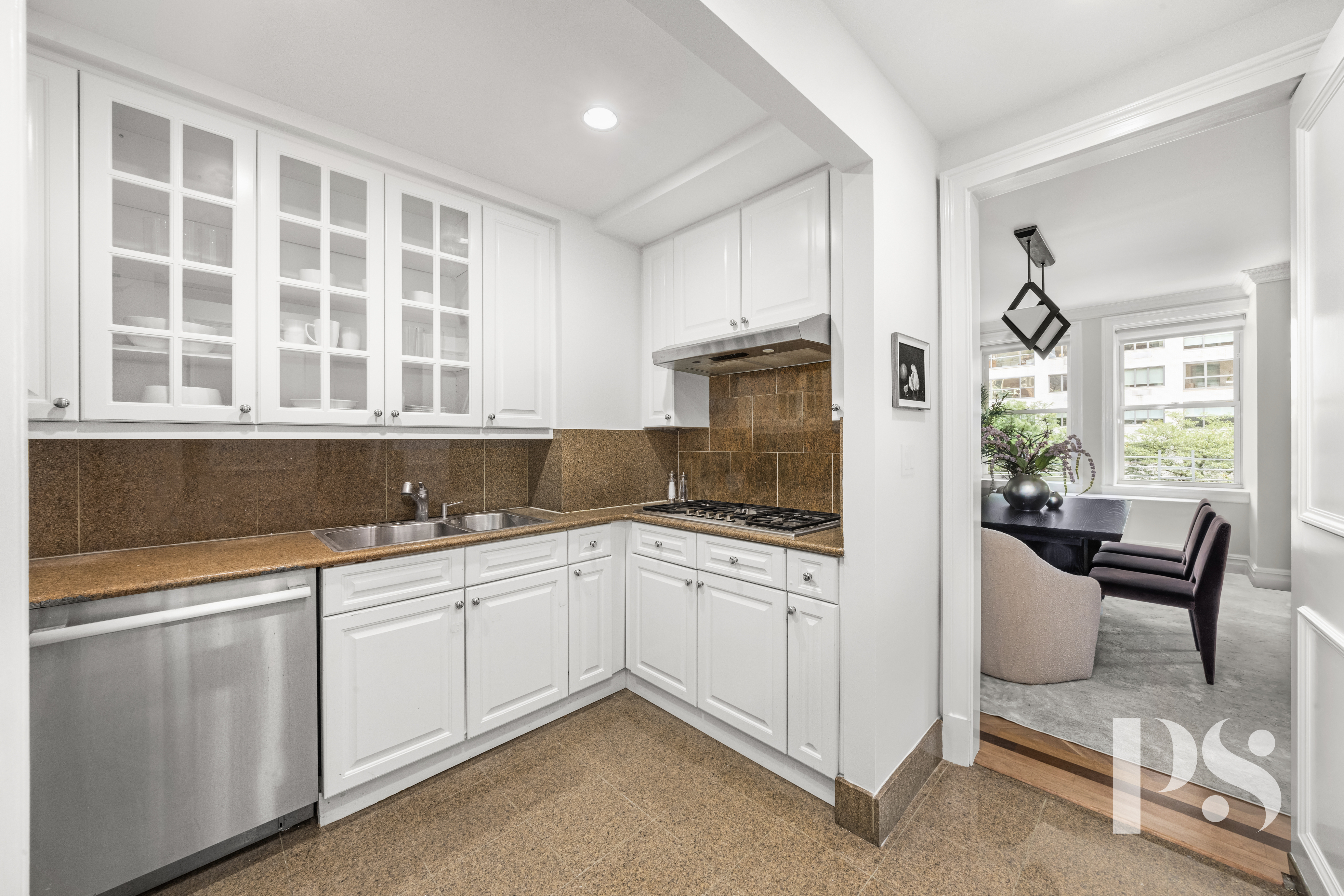 610 Park Avenue, Unit 4B Manhattan, NY 10065 - Photo 12 of 22 a kitchen with a sink cabinets and window