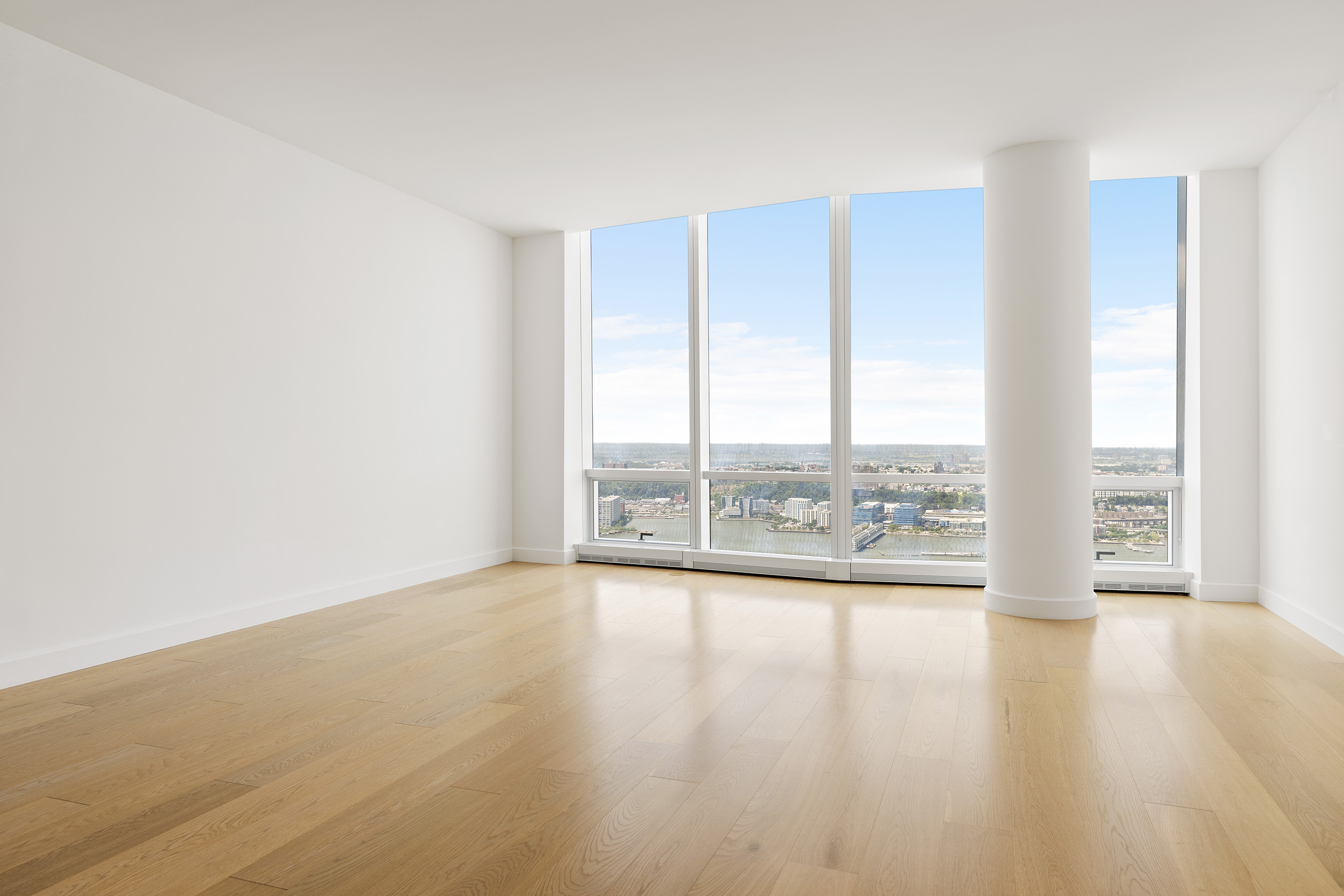 15 Hudson Yards, Unit 68C Manhattan, NY 10001 - Photo 2 of 16 a view of an empty room with wooden floor and a window