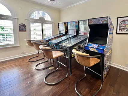a bedroom with a bed a dresser and flat screen tv