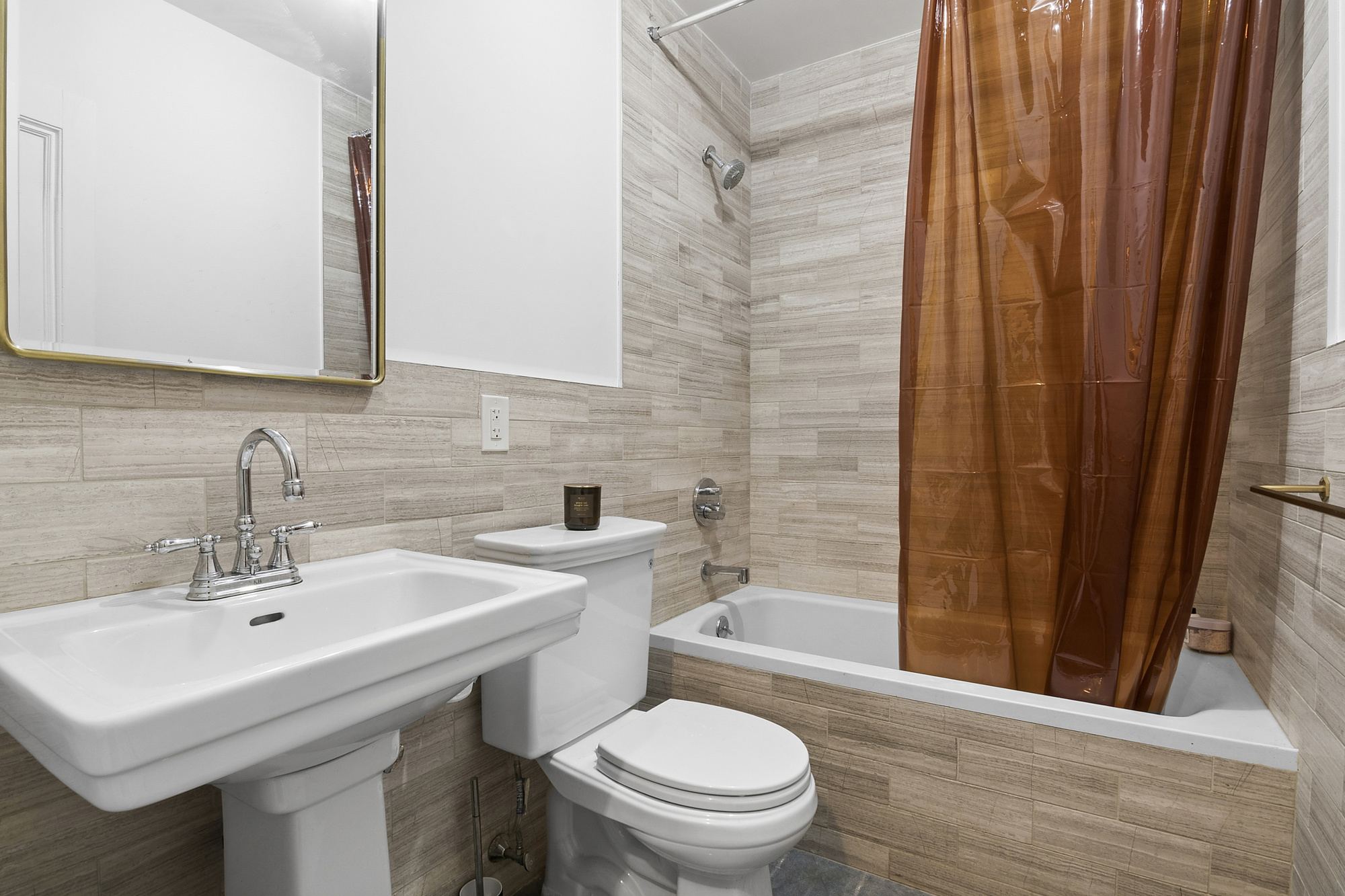 576 A MacDonough Street, Unit 1 Brooklyn, NY 11233 - Photo 4 of 6 a bathroom with a sink a toilet and shower curtain