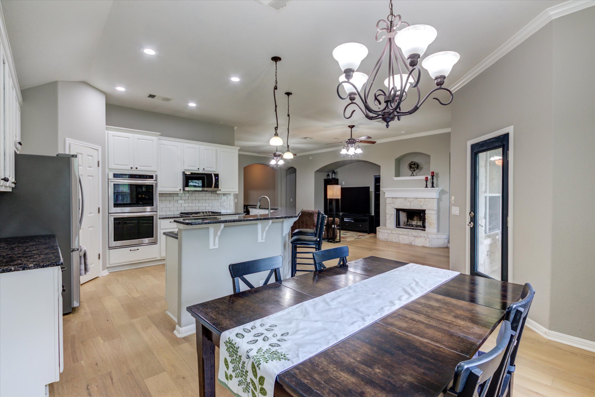 5412 Batak Lane Austin, TX 78749 - Photo 12 of 40 a large kitchen with granite countertop lots of counter space dining table and stainless steel appliances