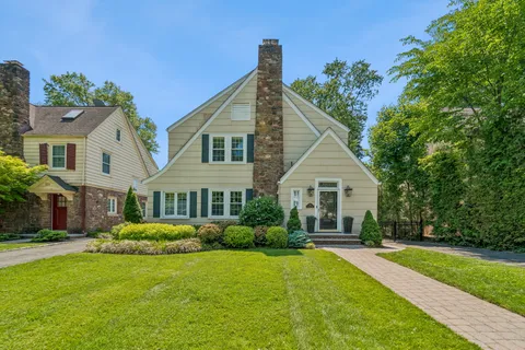 a front view of a house with a garden