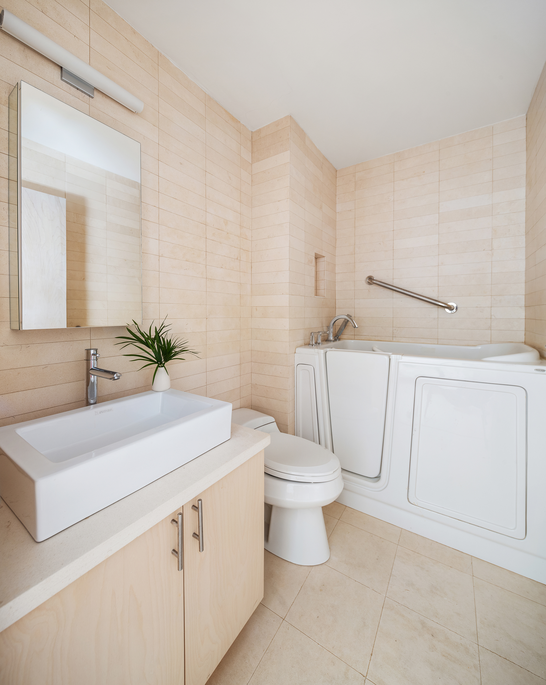 1065 Park Avenue, Unit 5BC Manhattan, NY 10128 - Photo 7 of 16 a bathroom with a sink a toilet and mirror