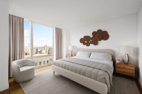 a bedroom with a bed and a large window