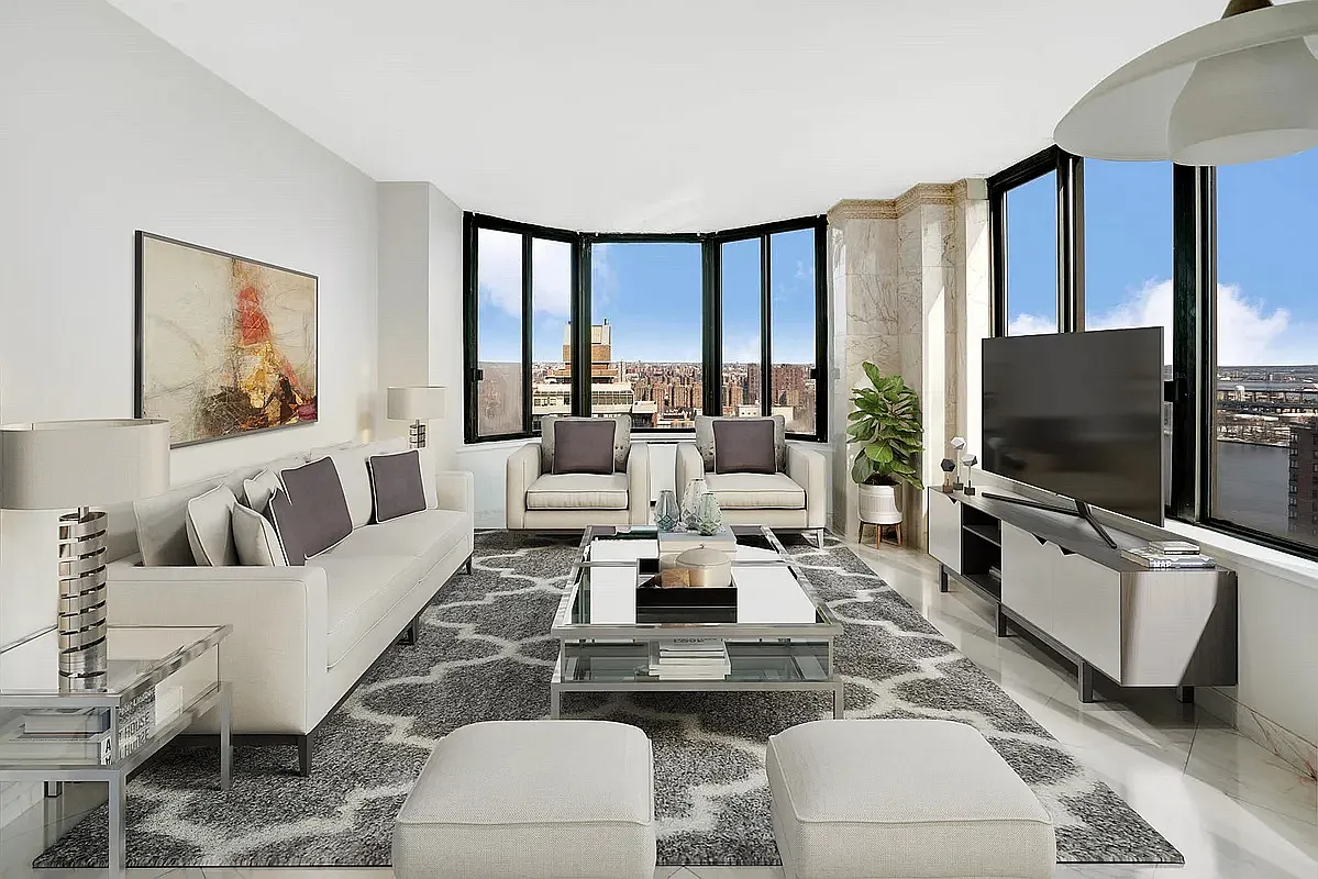 a living room with furniture a flat screen tv and a large window