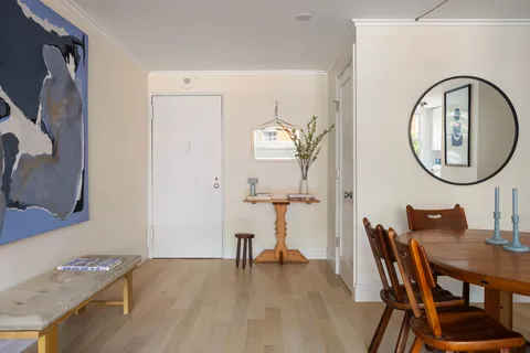 a view of a dining room with furniture and a mirror
