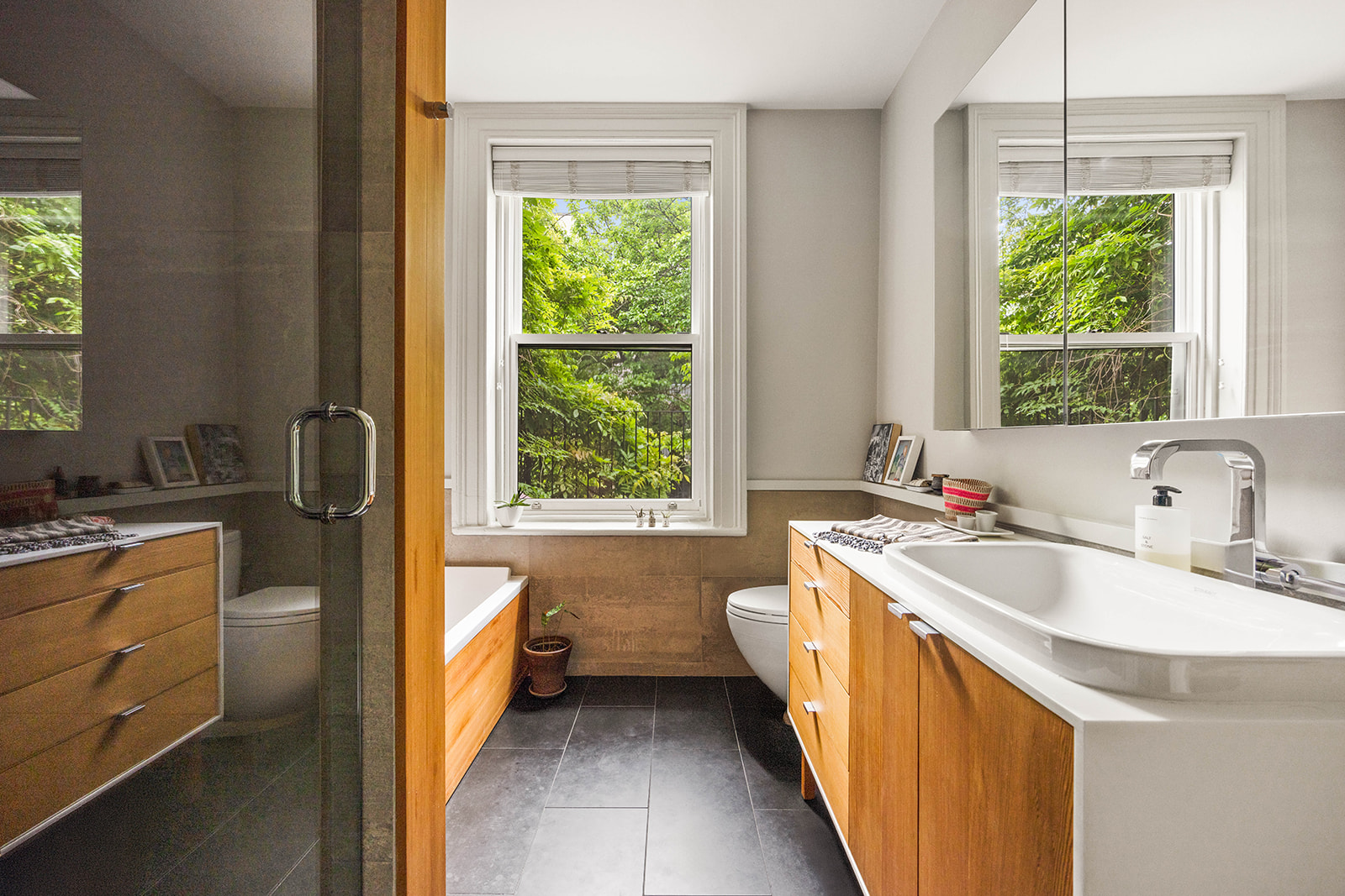 298 State Street Brooklyn, NY 11201 - Photo 13 of 21 a bathroom with a double vanity sink a toilet and a tub