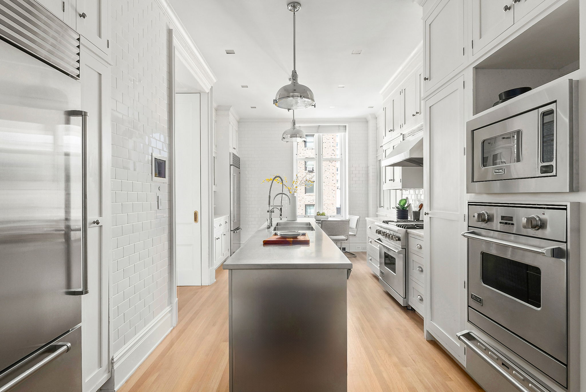 390 West End Avenue, Unit 4J Manhattan, NY 10024 - Photo 4 of 17 a kitchen with stainless steel appliances a stove a refrigerator and a stove