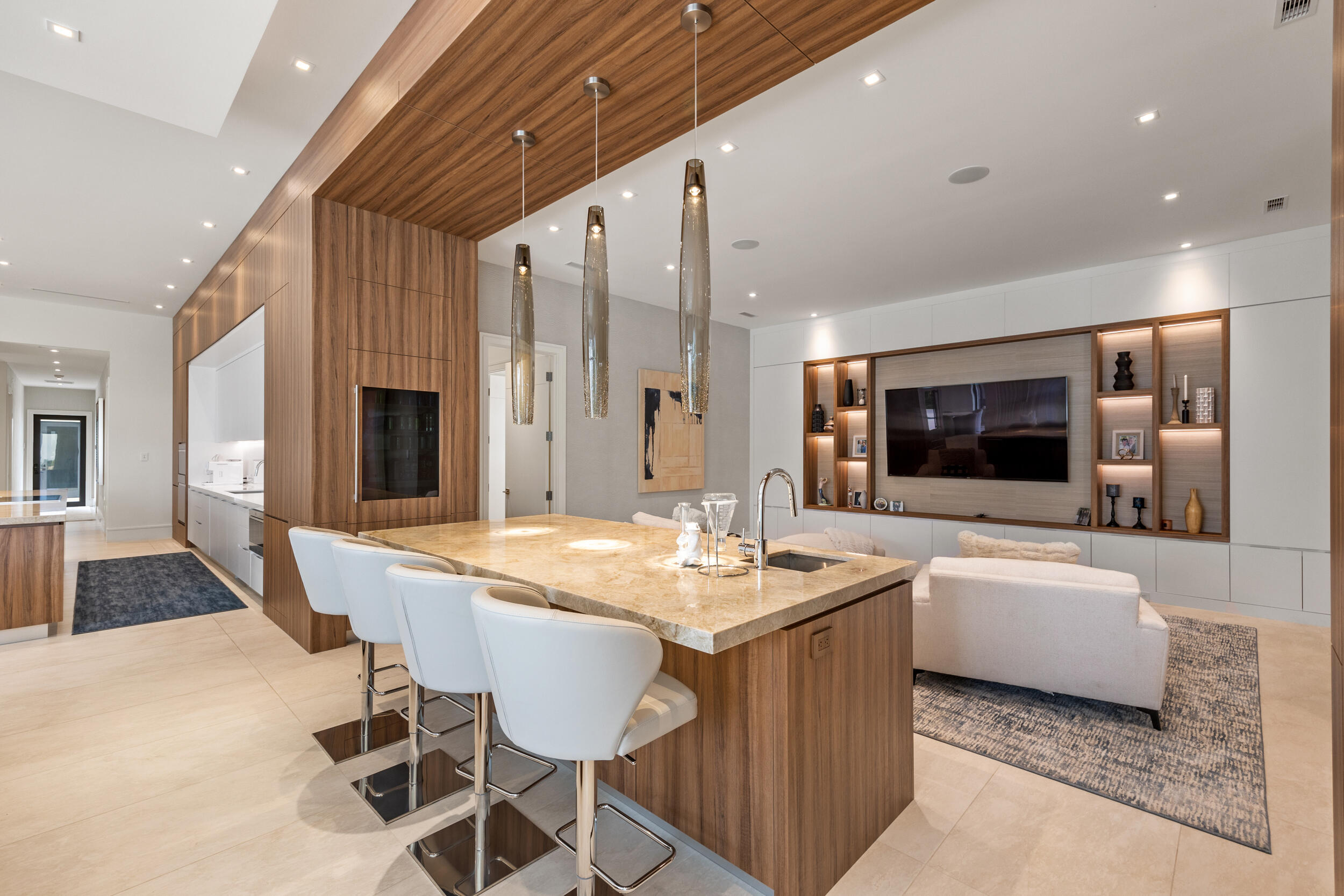 5695 Pennock Point Road Jupiter, FL 33458 - Photo 38 of 77 a dining hall with couches a flat screen tv and kitchen view