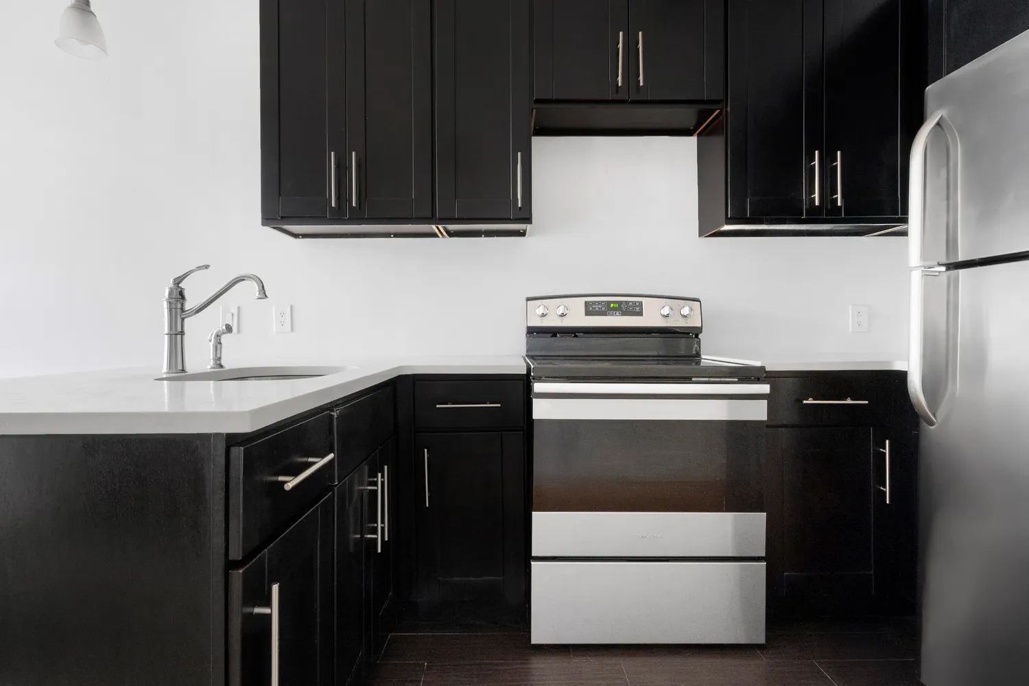a kitchen with granite countertop a stove and a microwave