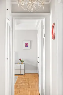 a hallway with painting and table