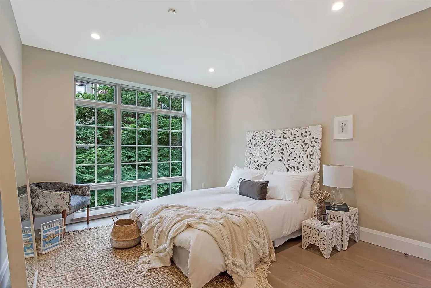 a bedroom with a bed and a large window