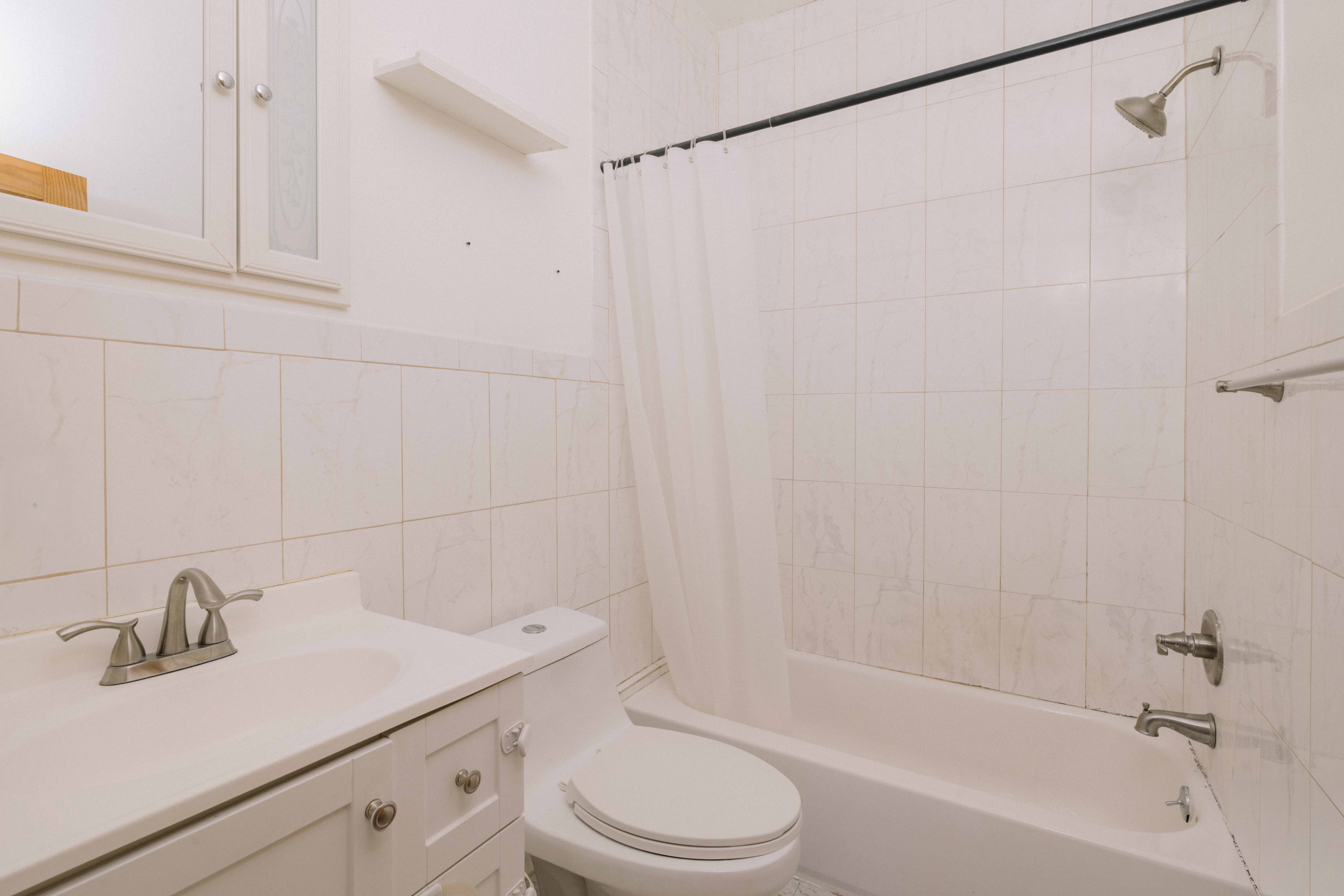 590 Monroe Street Brooklyn, NY 11221 - Photo 26 of 35 a bathroom with a sink toilet and shower
