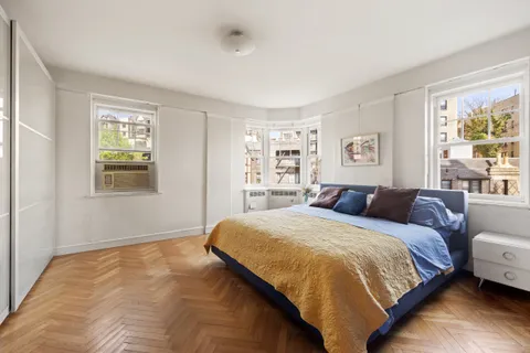 a bedroom with a large bed and a window