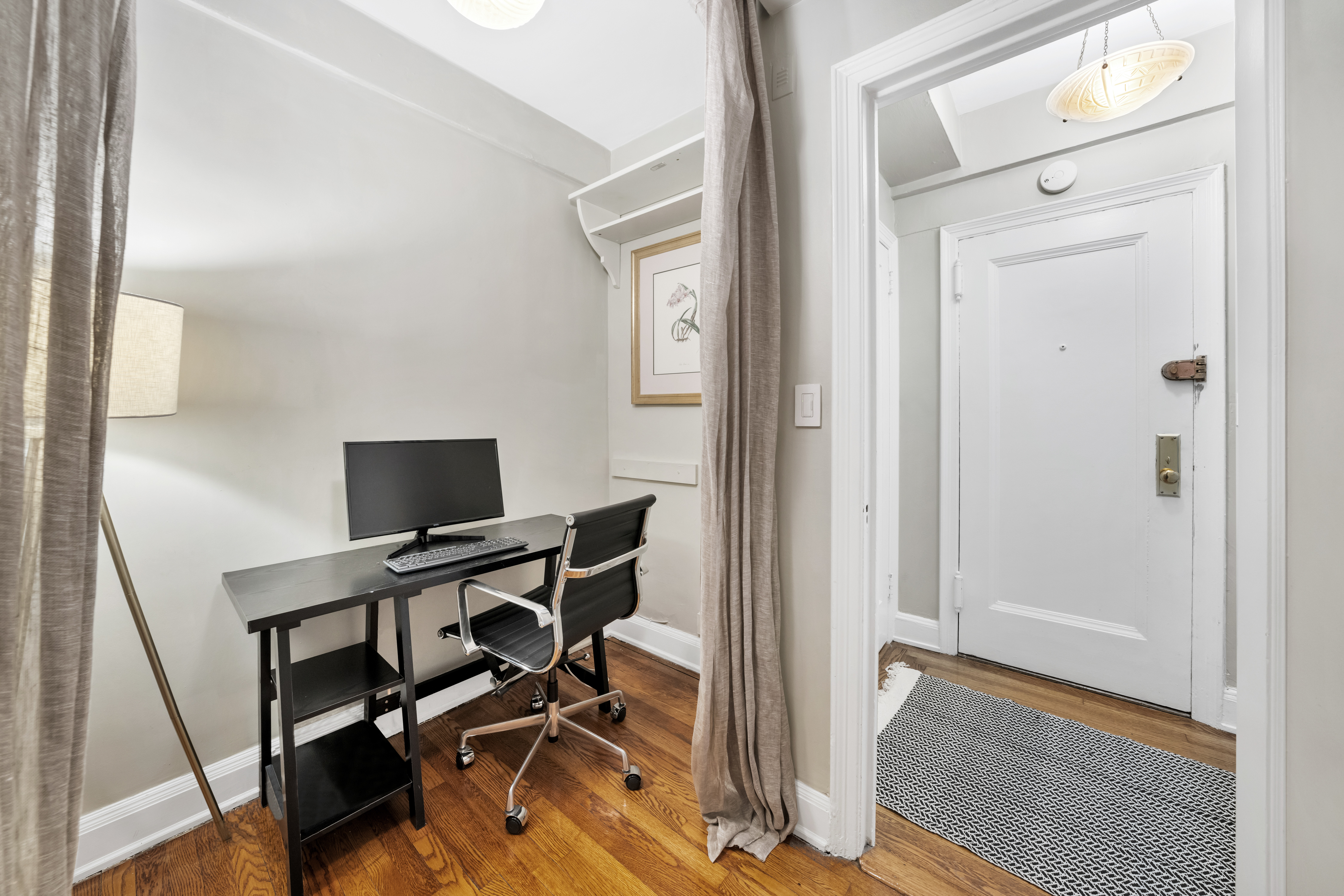 235 East 22nd Street, Unit 15M Manhattan, NY 10010 - Photo 5 of 14 a view of a workspace with furniture and wooden floor