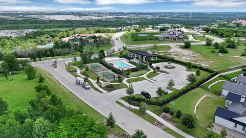 an aerial view of residential houses with outdoor space and river