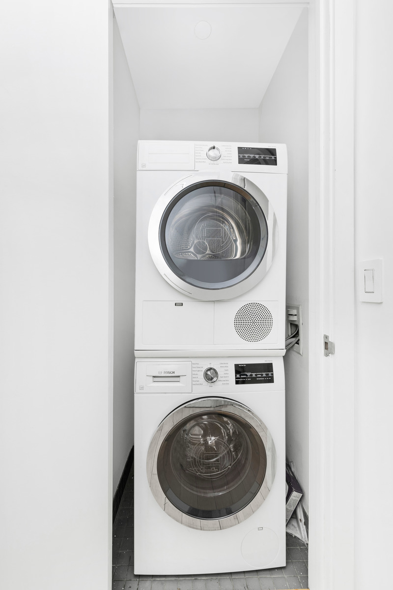 105 Norfolk Street, Unit 2A Manhattan, NY 10002 - Photo 12 of 16 a utility room with dryer and washer