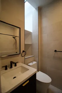 a bathroom with a sink toilet and mirror