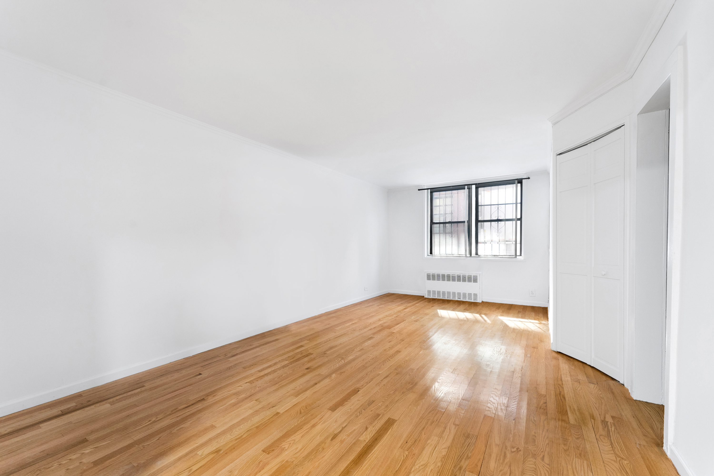 165 Christopher Street, Unit LV Manhattan, NY 10014 - Photo 2 of 16 a view of empty room with wooden floor and fan