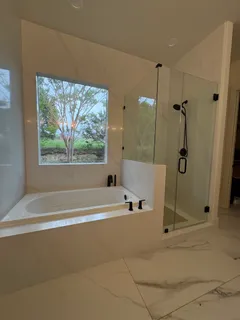 a bathroom with a tub and a shower