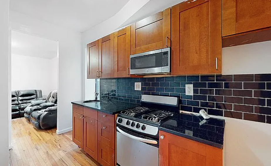 a kitchen with a stove a sink and a microwave