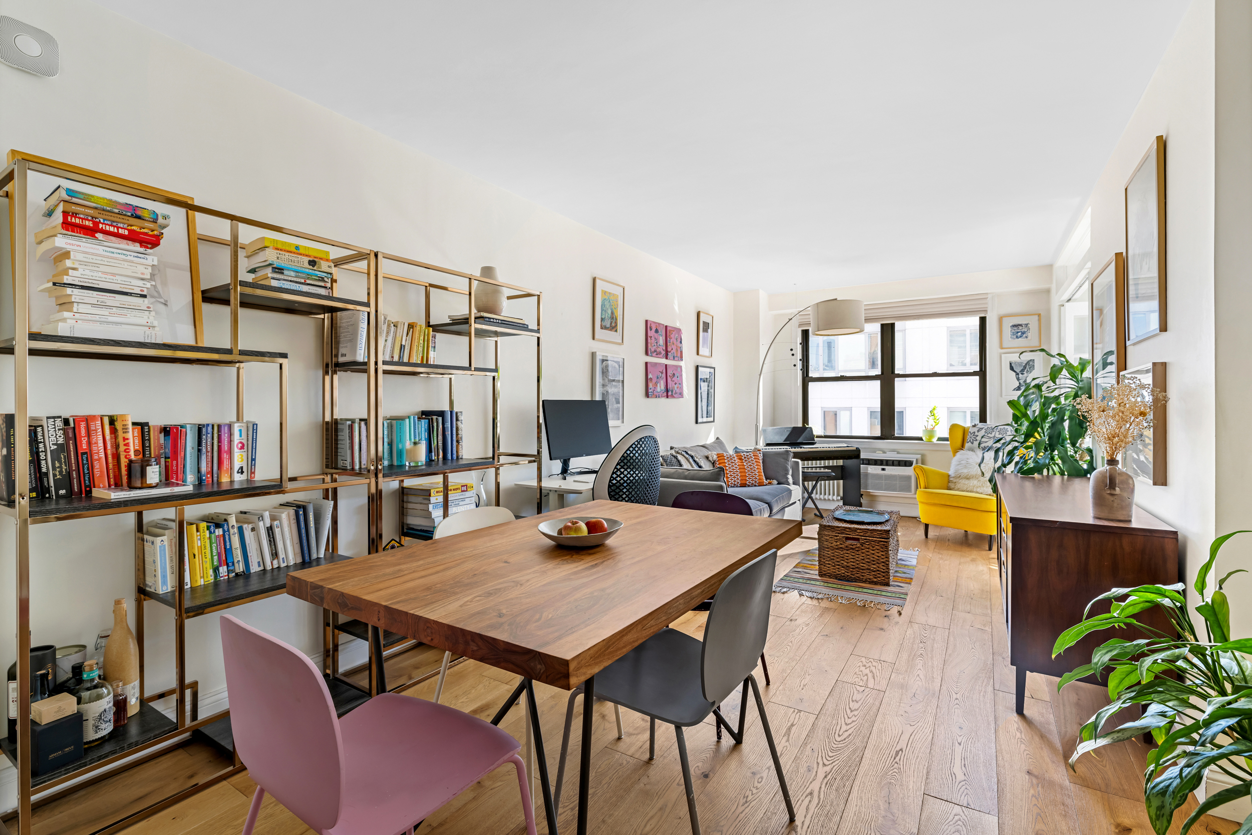 a living room with furniture and a book shelf