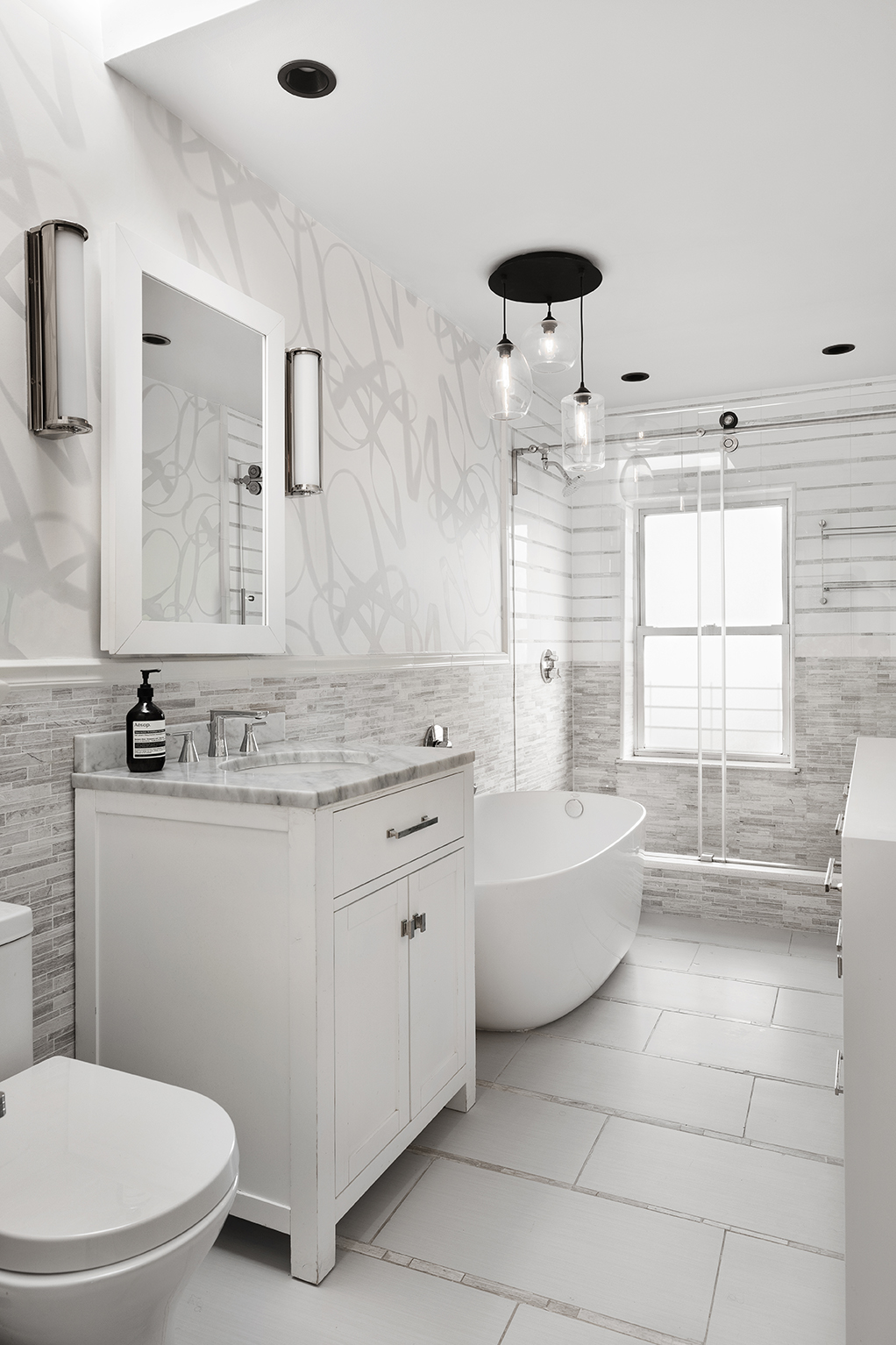 355 Pacific Street Brooklyn, NY 11217 - Photo 8 of 13 a bathroom with a granite countertop sink a toilet a mirror and bathtub
