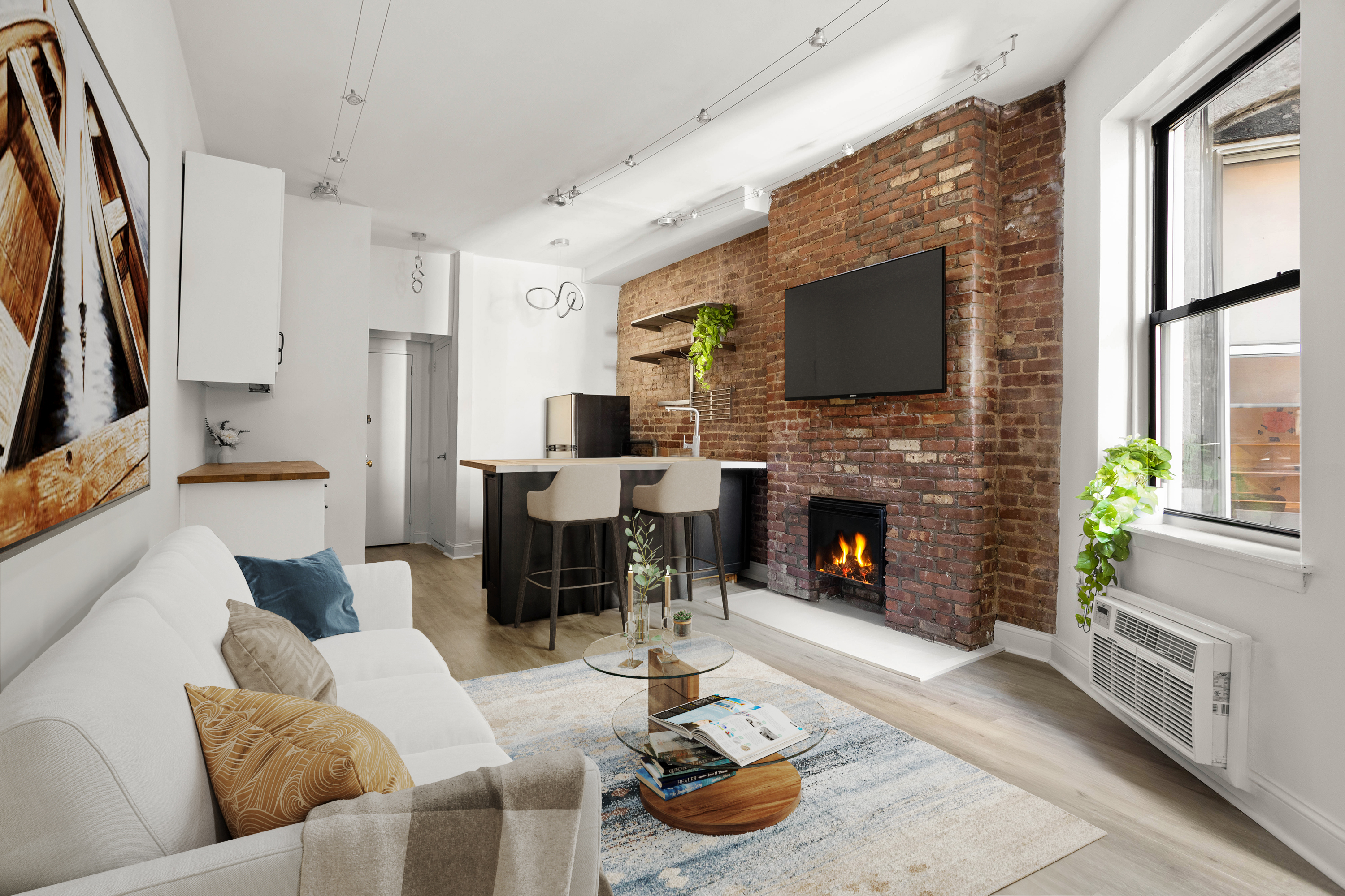 a living room with furniture a fireplace and a flat screen tv