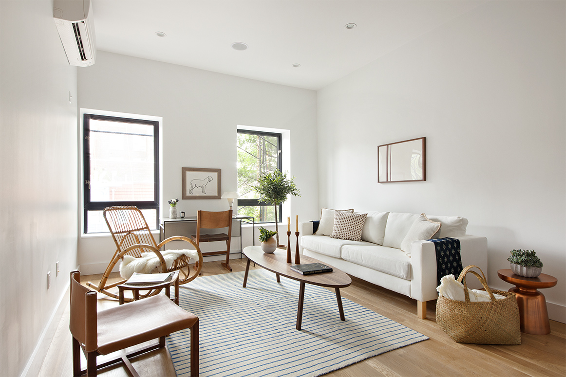 629 Grand Street, Unit 4A Brooklyn, NY 11211 - Photo 1 of 7 a living room with furniture wooden floor and a lamp