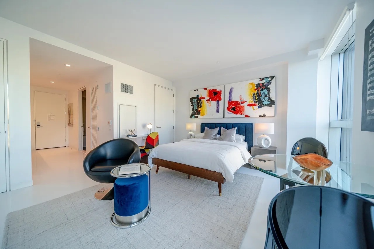 158 East 126th Street, Unit 730 Manhattan, NY 10035 - Photo 4 of 18 a living room with furniture a couch and a stool