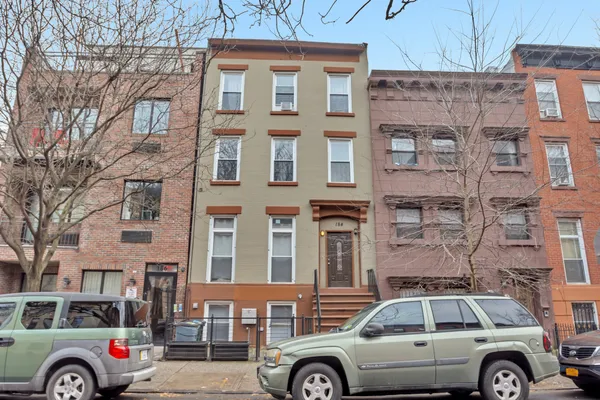 a front view of a building with parking space