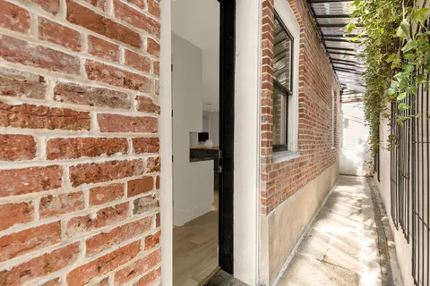 a view of a hallway with a room