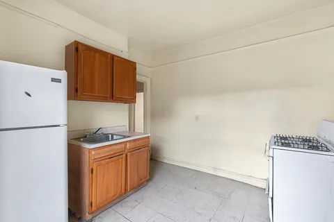 a kitchen with a refrigerator a stove a washer and dryer