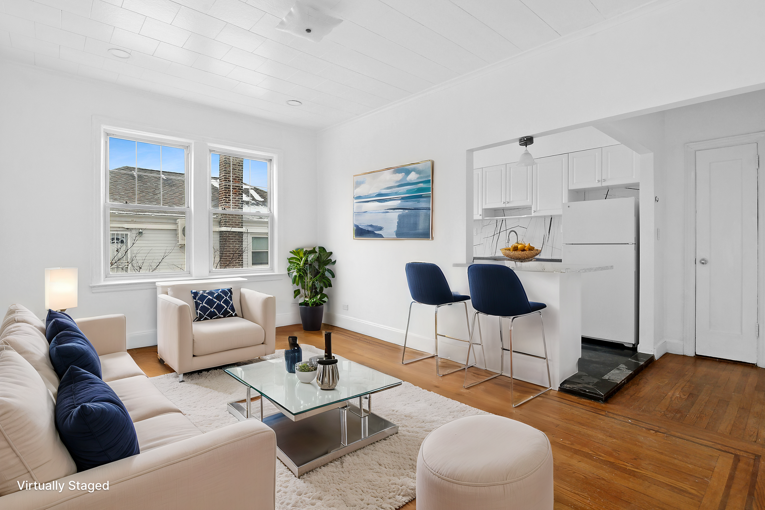 63-33 Haring Street, Unit 2F Queens, NY 11374 - Photo 1 of 7 a living room with furniture and a table