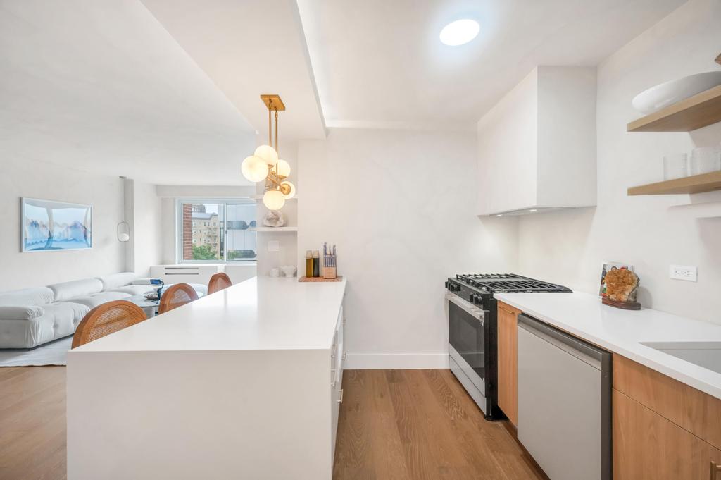 175 West 12th Street, Unit 5E Manhattan, NY 10011 - Photo 5 of 22 a kitchen with a sink a stove and refrigerator
