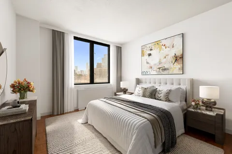 a bedroom with a bed and a painting on the wall