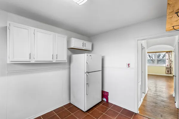 a white refrigerator freezer and a stove sitting inside of a kitchen