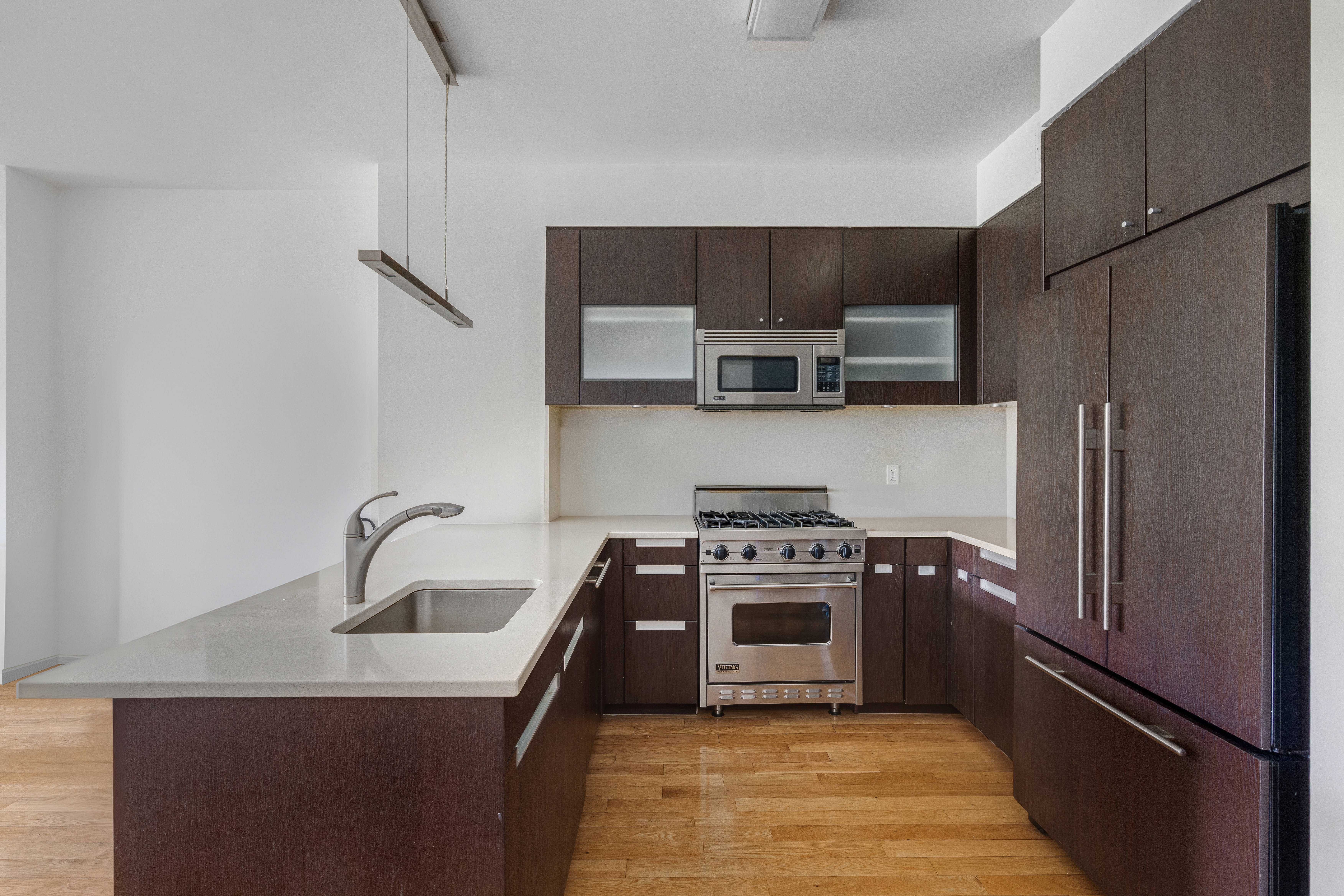 454 West 54th Street, Unit 3P Manhattan, NY 10019 - Photo 4 of 9 a kitchen with stainless steel appliances granite countertop a sink stove and refrigerator