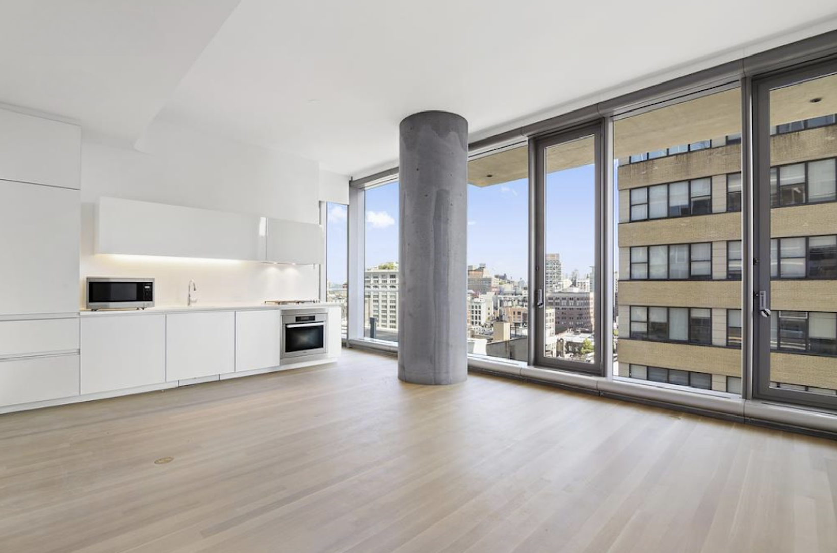a view of a living room with furniture and floor to ceiling window