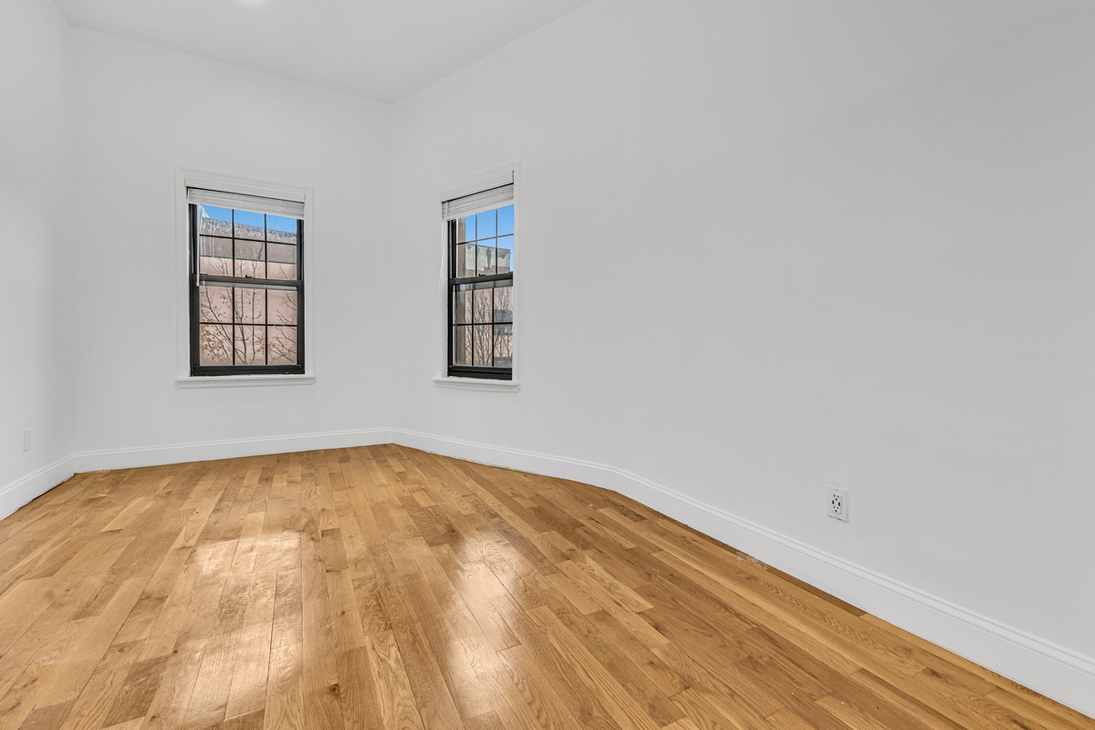 583 Evergreen Avenue Brooklyn, NY 11221 - Photo 6 of 12 a view of a room with window and wooden floor