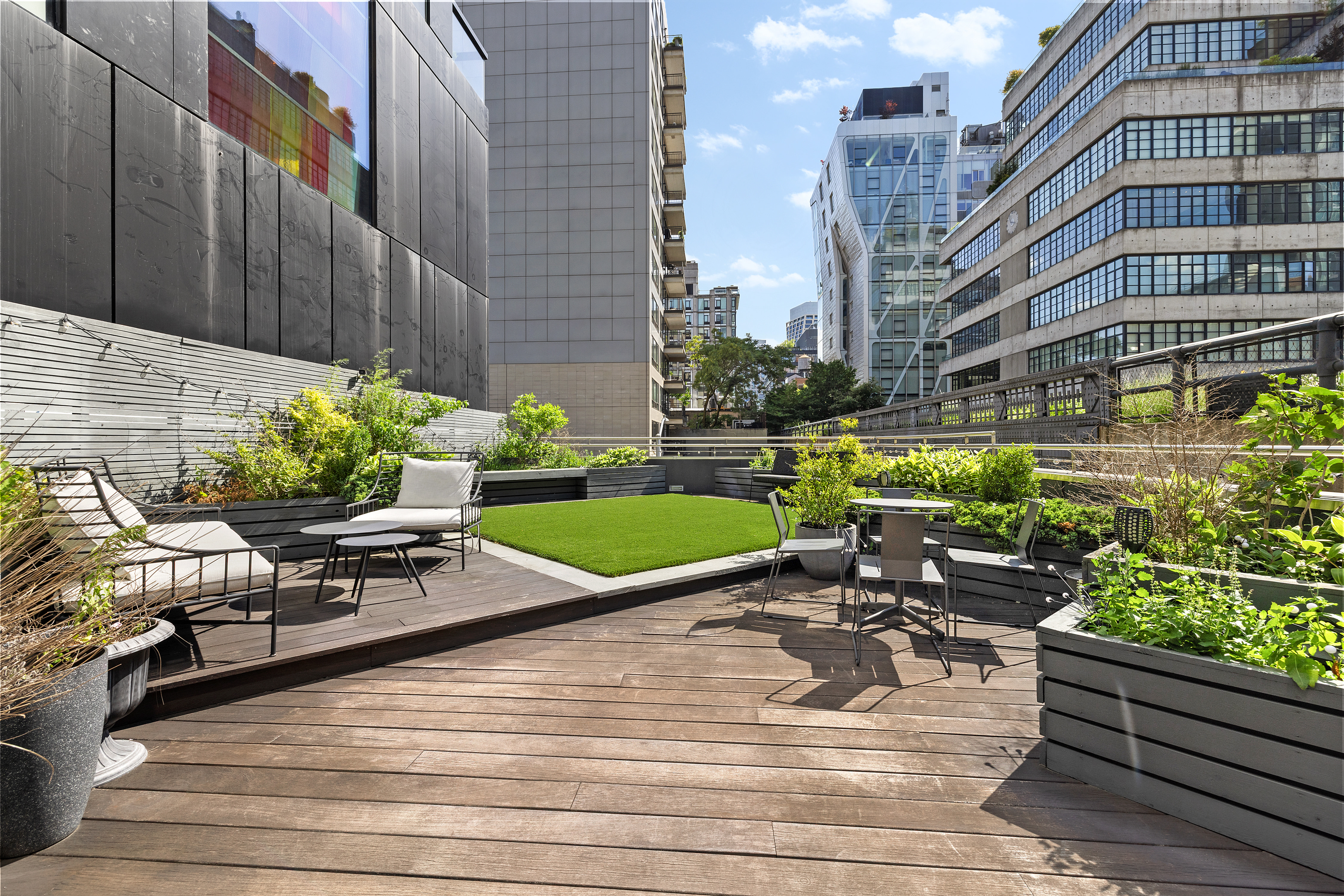 245 10th Avenue, Unit 2W Manhattan, NY 10001 - Photo 4 of 16 a view of a patio with couches chairs potted plants and wooden floor