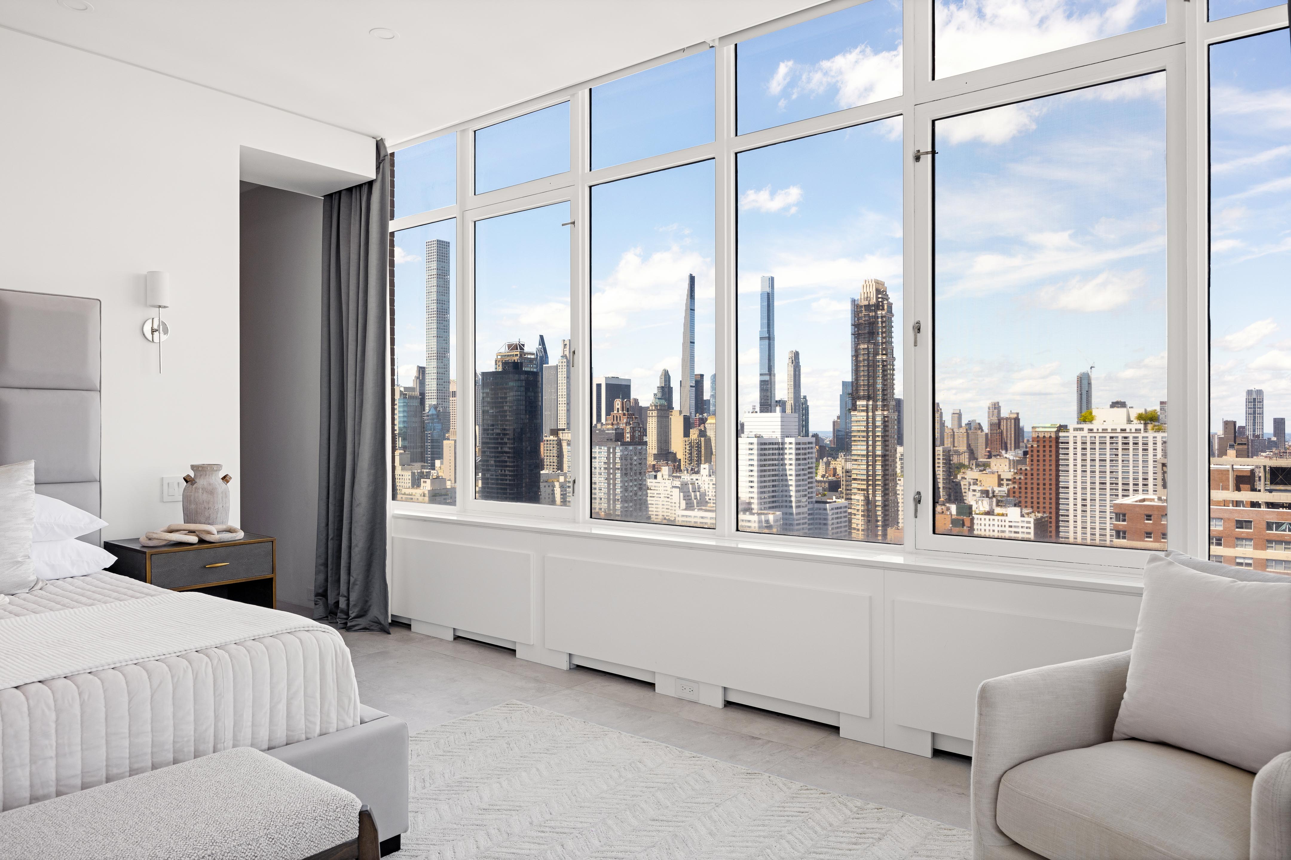 422 East 72nd Street, Unit 37AD Manhattan, NY 10021 - Photo 13 of 38 a bedroom with furniture and a large window