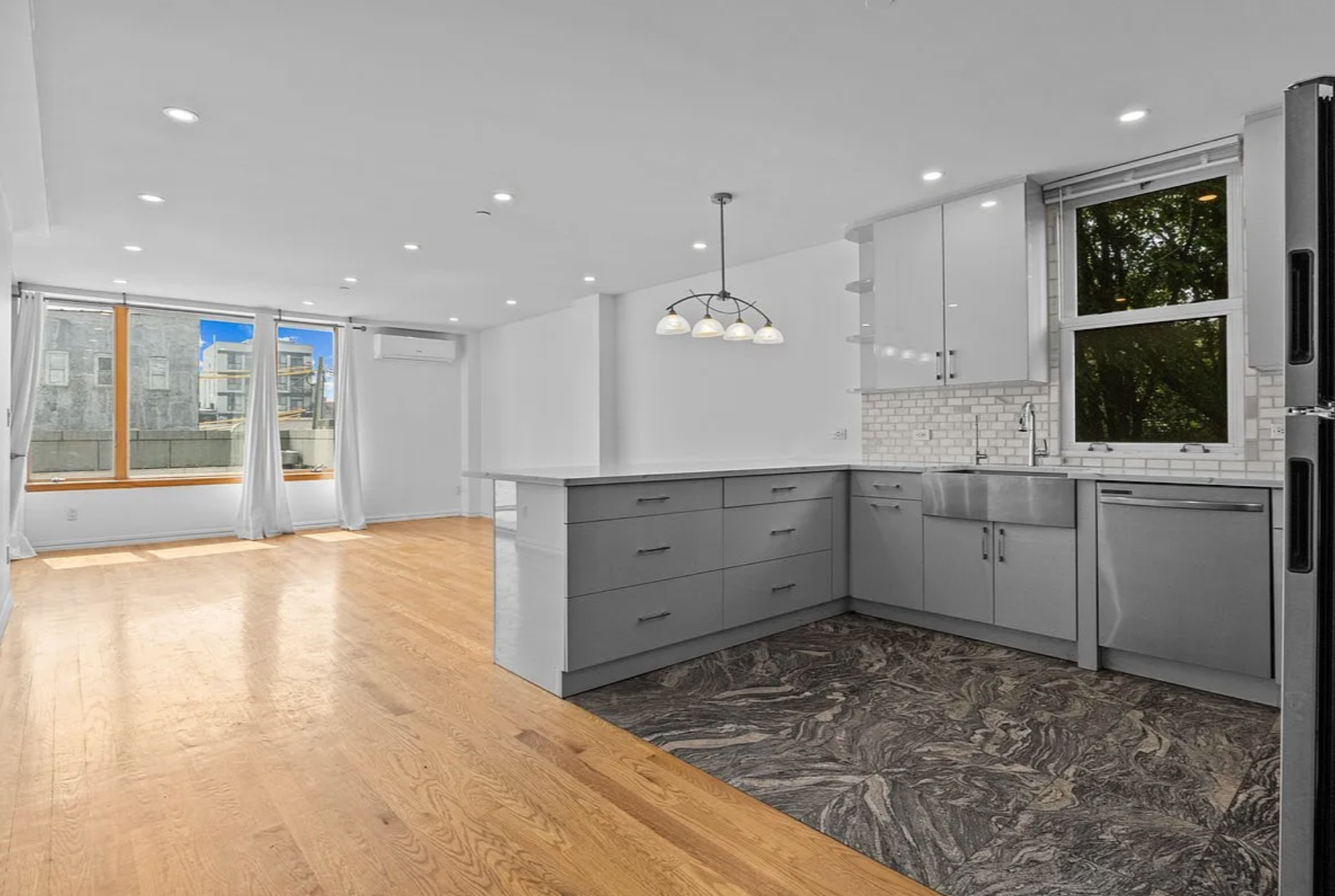 2882 West 15th Street, Unit 2B Brooklyn, NY 11224 - Photo 1 of 13 a view of a kitchen with a sink and dishwasher with wooden floor