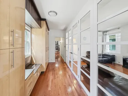 a view of a hallway with wooden floor and staircase