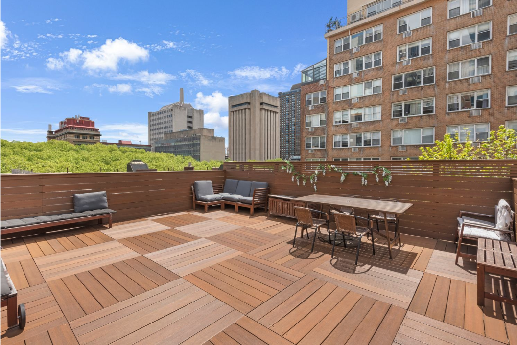 436 East 66th Street, Unit 4E Manhattan, NY 10065 - Photo 16 of 19 a roof deck with outdoor seating and city view
