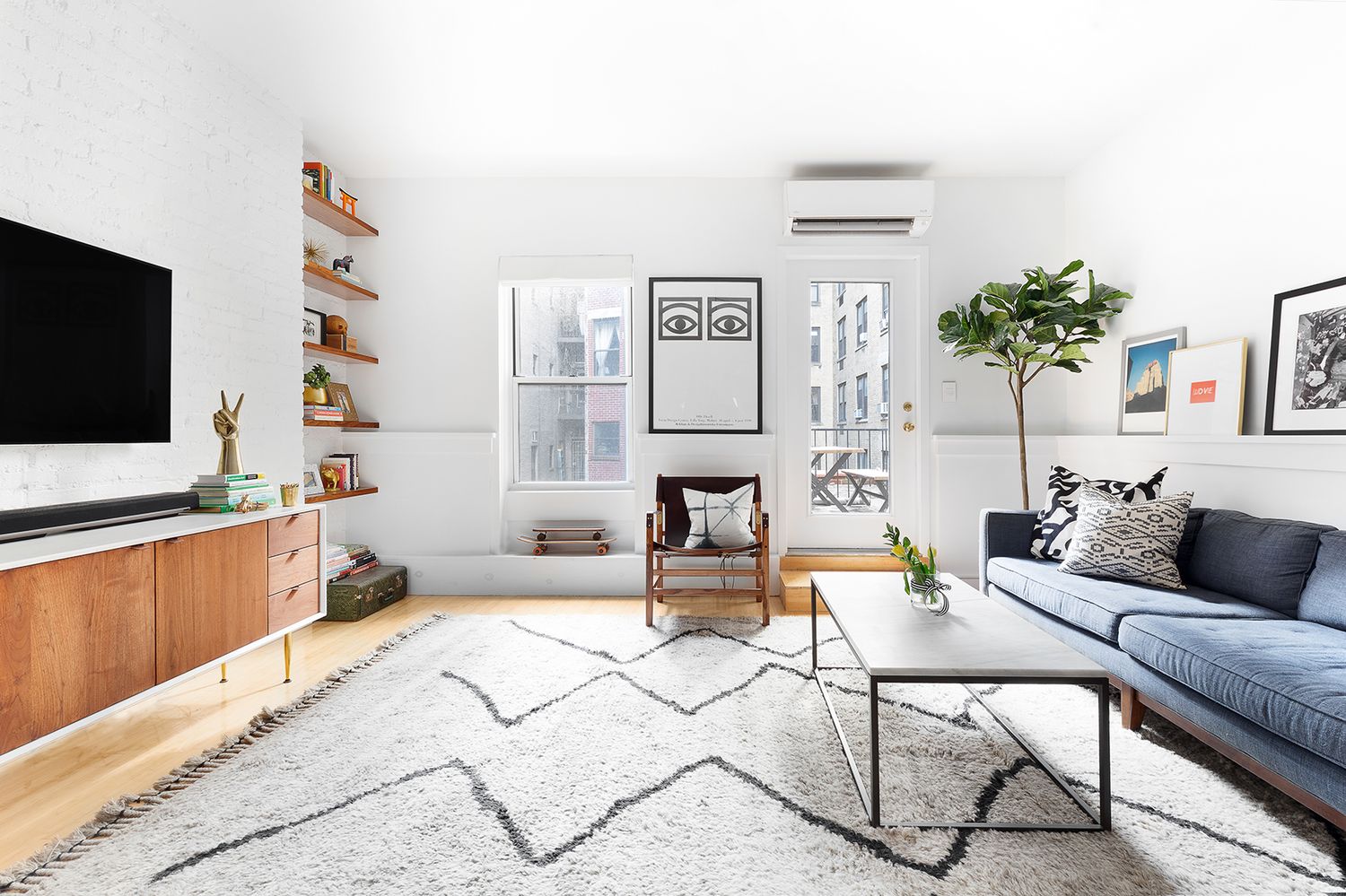 258 West 93rd Street, Unit 4AB Manhattan, NY 10025 - Photo 2 of 10 a living room with furniture and a flat screen tv