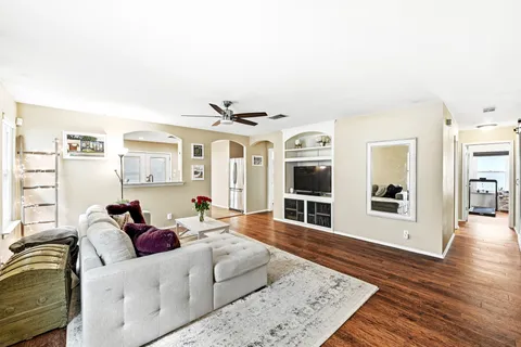 a living room with furniture and wooden floor